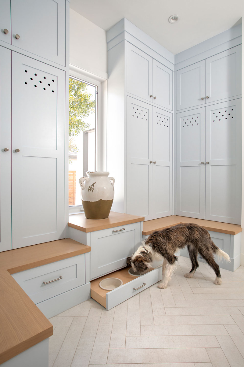 mud room cabinetry, mud room pet space, hidden pet dishes, custom cabinetry mud room, mud room paint colour ideas, mud room painted cabinets, mud room blue cabinets, herringbone tile floors, mud room floors