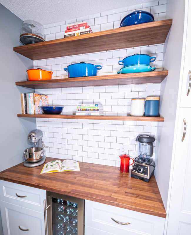 open shelving pantry, farmhouse pantry, custom floating shelves, diy floating shelves, walnut floating shelves, butlers plantry, subway tile pantry, walnut butcher block counter, ikea counter, ikea countertop, le creuset cookware, how to display le creuset cookware, how to display cookware, shelf styling pantry, pantry shelf style, pantry shelfie, cookbook display, coffee bar, kitch custom shelves